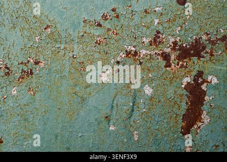 Weathered painted metal texture with rust corrosion and peeling paint. Distressed industrial surface showing age, oxidation and deterioration. Stock Photo