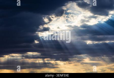 Dozens of sun rays breaking through clouds near Herefored Arizona early in the morning. Stock Photo