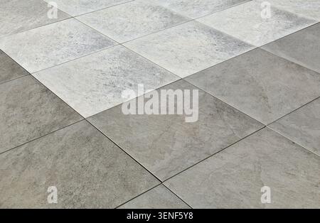 Gray and white porcelain stoneware tiles, natural stone effect. Outdoor pavers. Full frame, background and texture. Stock Photo