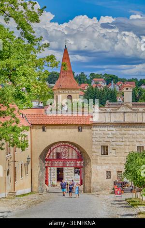 The main entrance into the Ist courtyard of the Český Krumlov castle from the town's side, Latran street, there is a wooden door called the Red Gate Stock Photo