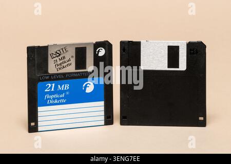 Pavia, Lombardy, Italy - November 23, 2024: Insite Peripherals 21MB Floptical Diskette 1991, front and back on beige background. Rare hybrid magnetic- Stock Photo