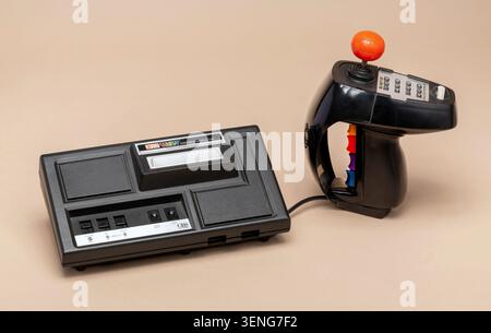 Pavia, Lombardy, Italy - March 30, 2026: CBS ColecoVision Expansion Module No.1 1982 with Super Action Controller on beige background. Retro gaming ac Stock Photo