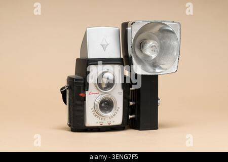 Pavia, Lombardy, Italy - December 27, 2024: Kodak Brownie Starflex 1957 with Sylvania M2 flash on beige background. Twin-lens style, Dakon lens, 127 r Stock Photo