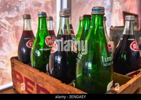Antique Dr Pepper and 7 Up Soda Bottles in Wooden Crate with Vintage Labels Stock Photo