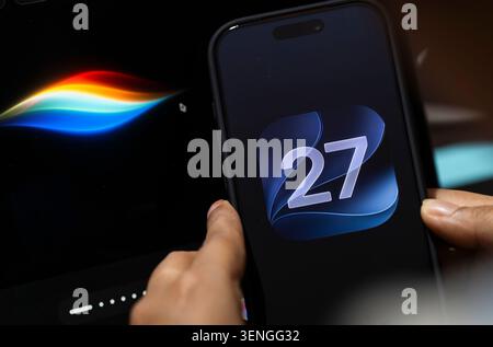 In this photo illustration, a person holds an iPhone displaying the iOS 27 logo beside a screen showing Apple's Siri interface on June 10, 2026, in New Delhi, India. Credit: David Talukdar/17�Թ����� Live News Stock Photo