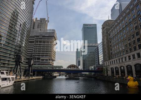 View across North Dock at Canary Wharf featuring modern skyscrapers, dockside cranes and waterfront architecture in London's business district. Stock Photo