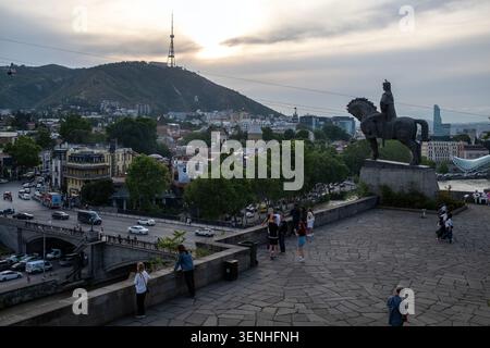 People visit Metekhi church of the Nativity of the Mother of God as Old Town Tbilisi is seen in the background in Georgia. Stock Photo