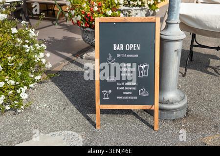 Bar open wooden chalkboard sign on street outside cafe Stock Photo