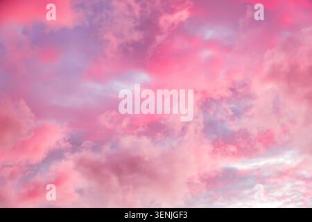 Fairytale sky with sugar cotton pink clouds in a dreamy background. Fantasy environment. Amazing heaven. Nature wallpaper. Idyllic backdrop. Romantic Stock Photo