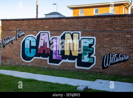 A colorful Greetings from Calne mural painted on a brick wall in Wiltshire, England Stock Photo
