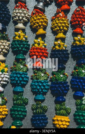 Colorful traditional ceramic pinecone and cactus souvenir magnets arranged in rows on a display. High quality photo Stock Photo