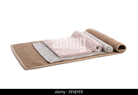 Assortment of rolled and flat bath mats in various textures and colors, home decor and bathroom textile products Stock Photo