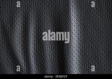 Dark gray perforated leather texture background with subtle wrinkles and small holes for automotive and upholstery design Stock Photo