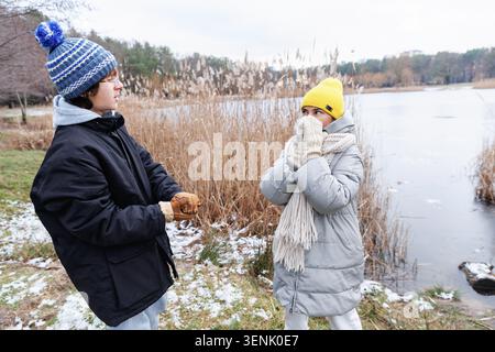 Mother and teen son having emotional conversation outdoors Stock Photo