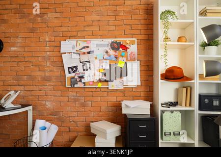 Detective investigation board with crime scene evidence and clues on brick wall background, the board is mounted on a textured brick wall, a dedicated Stock Photo
