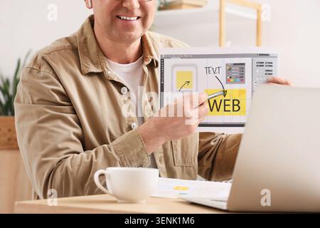 Man presenting web design layout with stylus pen, user interface development and digital marketing strategy Stock Photo