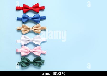 Different stylish bow ties on blue background Stock Photo