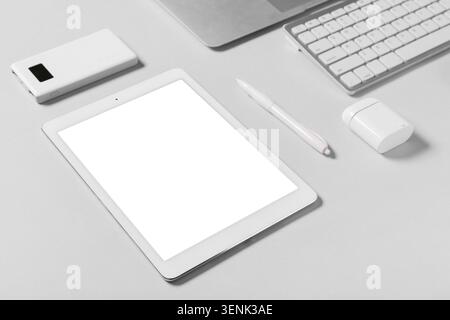 Tablet computer with different modern gadgets on grey background Stock Photo