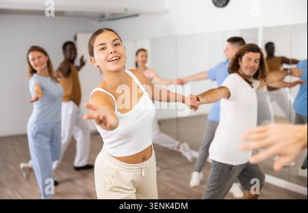 Adult couples dancing active dance together in studio Stock Photo