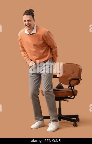 Young man experiencing abdominal pain or discomfort, health issues and medical conditions, isolated studio shot Stock Photo