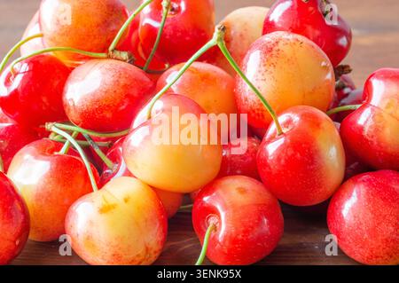 Ripe sweet cherries lie on a wooden background.. Close-up Stock Photo