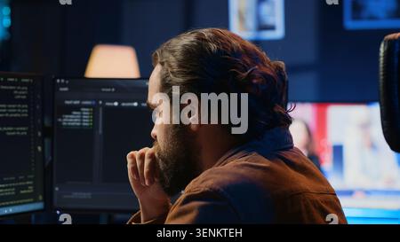 Developer overthinking solutions while doing programming during remote job shift in home office. IT admin working on computer in apartment late at night, thinking how to fix bugs, camera A close up. Stock Photo