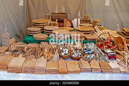 Handcrafted kitchen tools various wooden natural wood products ranging from smooth cutting boards to rustic spoons and bowls Stock Photo