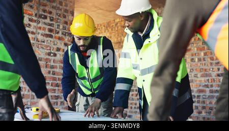 Engineer, blueprint and architect with team in discussion, meeting or planning at construction site. Men, group collaboration and project with floor Stock Photo