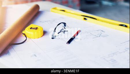 Construction, blueprint or glasses with tools on table for project development, design or planning. Engineering, equipment and paperwork on site for Stock Photo