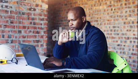 Planning, black man and architect in office with laptop for project, blueprint or building development. Brainstorming, computer and male structural Stock Photo
