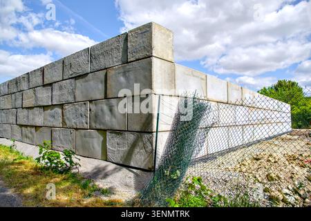 Retaining wall on building site made from large Lego concrete blocks - Preuilly-sur-Claise, Indre-et-Loire (37), France. Stock Photo