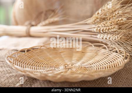 Empty Wicker Bread Basket With Wheat Ears On Rustic Burlap Fabric Stock Photo