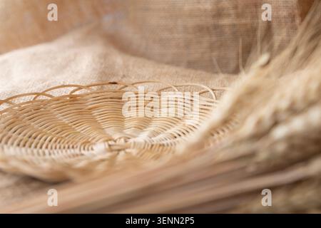 Empty Wicker Bread Basket With Wheat Ears On Rustic Burlap Fabric Stock Photo