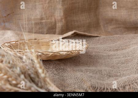 Empty Wicker Bread Tray On Rustic Burlap With Wheat Ears Stock Photo