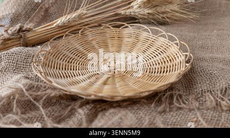 Empty Wicker Bread Tray On Rustic Burlap With Wheat Ears Stock Photo