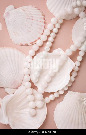 White agate gemstone beads necklace layered on natural sea shells. Stock Photo