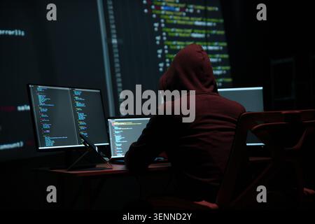 Programmer Hacker Working at Multiple Computer Monitors Stock Photo