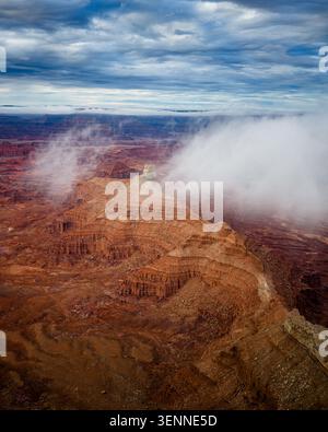 Dramatic clouds sweep over vast red rock canyon Stock Photo