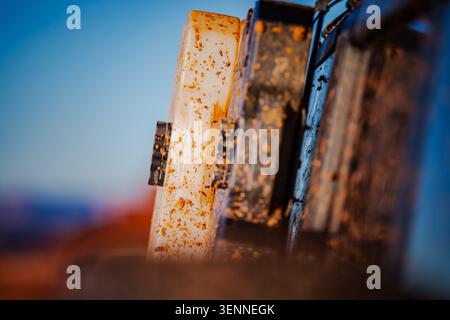 Mud splattered equipment sits under a clear blue sky Stock Photo