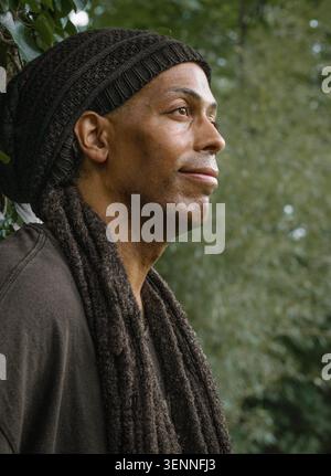 Thoughtful man with dreadlocks looking into the distance Stock Photo