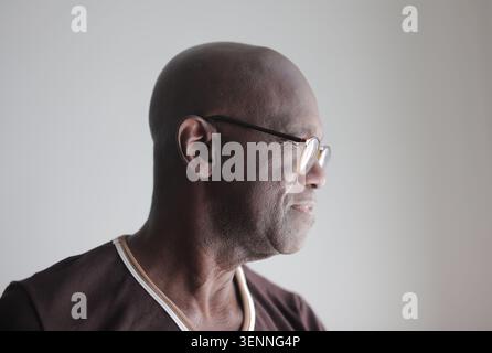 Profile portrait of a senior bald Black man wearing glasses Stock Photo