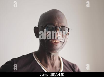 Happy senior black man with glasses smiling Stock Photo