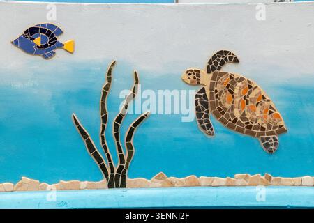 Sea life mosaics with fish, turtle and seaweed on wall outside public restrooms, Queens Street, Speightstown, Barbados Stock Photo
