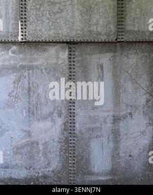 Vertical close up of weathered galvanized metal water tank panels with water marks Stock Photo