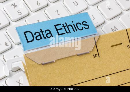 A brown file folder labeled with Data Ethics Stock Photo