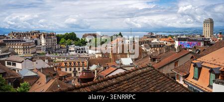 Lausanne, Switzerland - June 4, 2026: Panoramic view over red rooftops and old buildings in a historic swiss city of Lausanne under a cloudy sky. Stock Photo