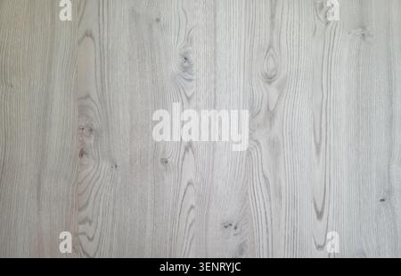 Light grey wood texture background with natural grain patterns and knots for interior design. Stock Photo