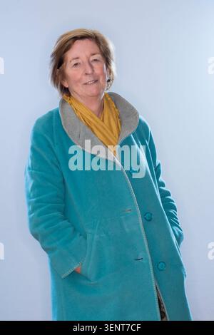 Portrait of writer Pat Barker in blue coat with yellow scarf. Stock Photo