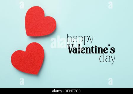 Happy Valentine's day card with red hearts on light blue background Stock Photo