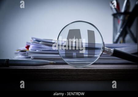 Magnifying glass highlighting AI letters over stacked documents on a desk, representing artificial intelligence, data analysis, auditing, technology, Stock Photo